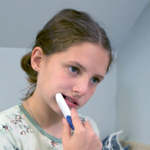 Dental-Pain-Eraser_girl-at-home-with-dpe